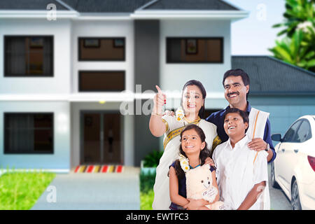 South Indian Parents and son Courtyard finger showing Stock Photo
