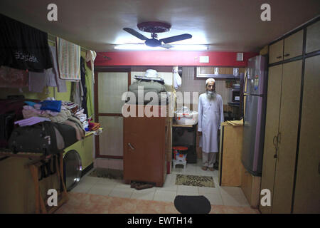 Mumbai, Maharashtra, India. 4th Sep, 2013. 4 Sept. 2013 : Bhendi Bazaar, Mumbai, INDIA:.Juzer Nullwala at his one room cramped home at Bhendi Bazaar, he is happy about the re-development project under taken by the Saifee Burhani Upliftment Trust.STORY :.In Bhendi Bazaar, a market district, in the heart of Mumbai, dilapidated old buildings line the streets. Many have cramped, dark, dingy interiors with crumbling staircases. Some are precariously supported by bamboo poles. Giant rats scurry across the floors. Such decayed surroundings ought to be deserted, but Bhendi Bazaar district, whe Stock Photo