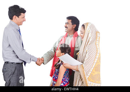 indian Rural Parents and Salesman Dealing Stock Photo