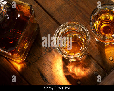 close up view of  nice bottle and two glasses filled with whiskey Stock Photo