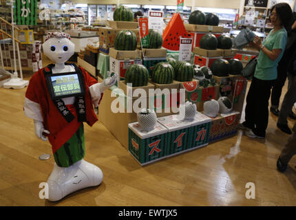 Tokyo, Japan. 1st July, 2015. A Softbank's humanoid robot 'Pepper' works as a part-time staff at a specialty shop selling Tottori prefecture's products in Tokyo, Japan, July 1, 2015. 'Pepper' will work at the shop until July 2 with 1,500 JPY (about 12 U.S. dollars) per hour. Credit:  Stringer/Xinhua/Alamy Live News Stock Photo