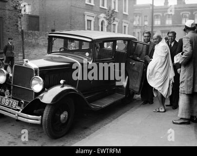 Mohandas 'Mahatma' Gandhi, leader of the  Indian independence movement in British-ruled India, pictured during his visit to Britain in 1931. Mahatma Gandhi seen here entering a car outside Kingsley Hall at Bromley by Bow in London. 3rd October 1931. Stock Photo