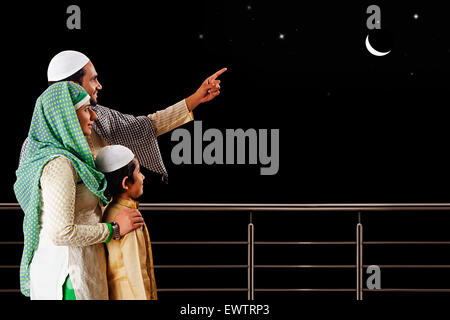 indian Muslim Parents and son showing moon Stock Photo