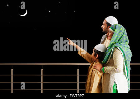 indian Muslim Parents and son showing moon Stock Photo