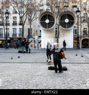 Paris, Place Georges Pompidou. street performer playing guitar and air vents, ventilation pipes in the public square Stock Photo