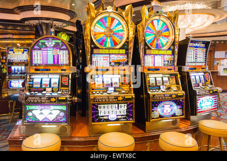 Slot machines in casino on board Royal Caribbean 'Brilliance of the Seas' cruise ship, North Sea, Europe Stock Photo