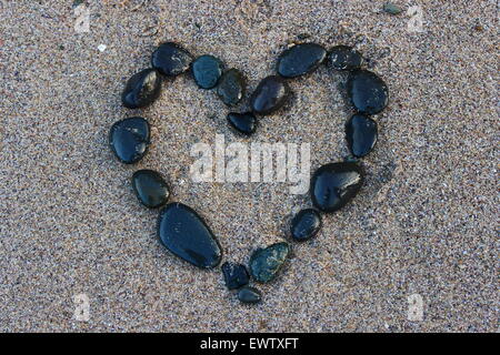 Black heart in the sand Stock Photo