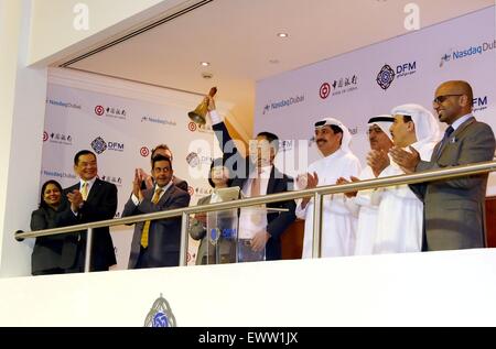 Dubai, United Arab Emirates (UAE). 1st July, 2015. General manager of the Abu Dhabi branch of the Bank of China (BOC) Tian Jun (5th R) rings market bell at the Dubai International Financial Center in Dubai, the United Arab Emirates (UAE), on July 1, 2015. BOC's Abu Dhabi branch listed here on Wednesday its two billion yuan (322 million U.S. dollars) bonds for the Belt and Road initiative on Nasdaq Dubai, the Middle East's only international exchange. © Li Zhen/Xinhua/Alamy Live News Stock Photo