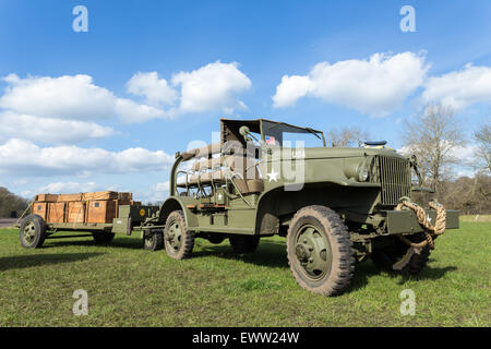 Military jeep pulling trailer carrying wooden boxes with bullets for war Stock Photo