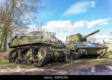 Two military tanks parked for exhibition in nature with blue sky and white clouds Stock Photo