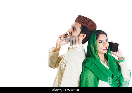 2 indian Muslim Married Couple talking Cell Phone Stock Photo