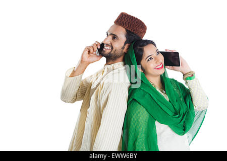 2 indian Muslim Married Couple talking Cell Phone Stock Photo