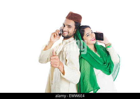 2 indian Muslim Married Couple talking Cell Phone and thumbs up showing Stock Photo