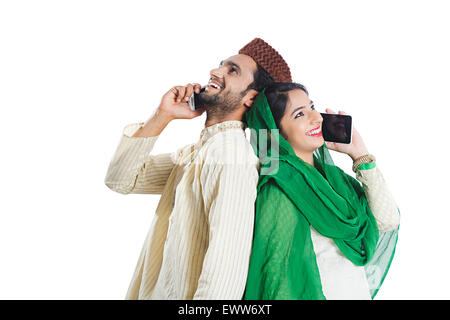 2 indian Muslim Married Couple talking Cell Phone Stock Photo