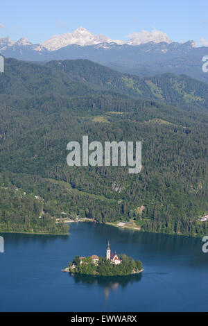 AERIAL VIEW. Bled Island on Lake Bled. Triglav National Park in the distance. Bled, Upper Carniola, Slovenia. Stock Photo