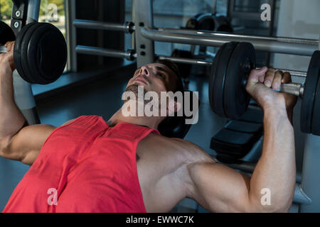 Man Doing Incline Chest Presses With Dumbbells In Gymnasium Stock Photo
