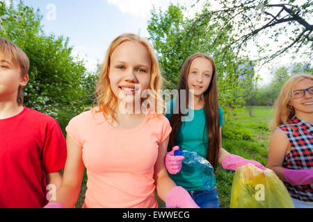 Close-up of teens with gloves and garbage bags Stock Photo