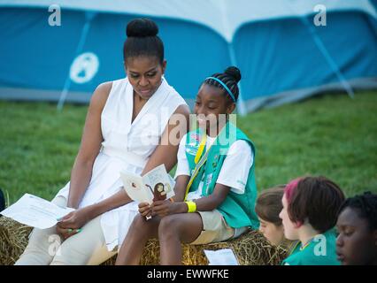 U.S. First Lady Michelle Obama talks with Girl Scouts during the first-ever White House Campout with fifty fourth-grade girls as part of the Let's Move! Outside initiative on the South Lawn of the White House June 30, 2015 in Washington, DC. In addition to the campout the girls enjoyed stargazing activity with scientists and astronaut Cady Coleman. Stock Photo