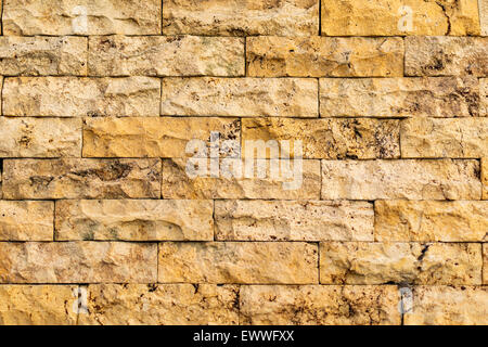 Old wall made of yellow-beige color bricks with detailed texture. Stock Photo