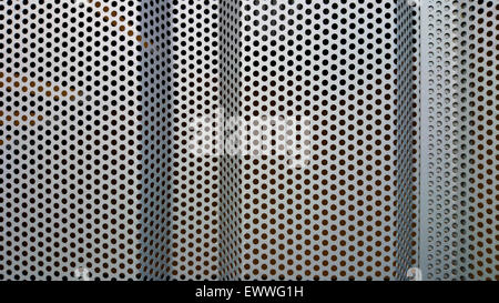 Metal wall profile with round holes as background Stock Photo