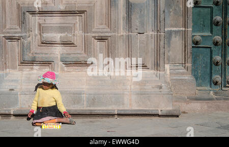 Girl by a wall in Cusco, Peru. Stock Photo