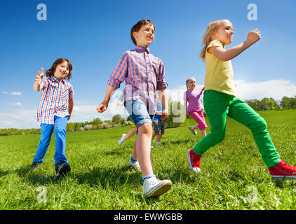 View from below of children running in the park Stock Photo