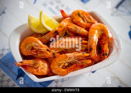 Fresh grilled shrimps with lemon close up, soft focus Stock Photo