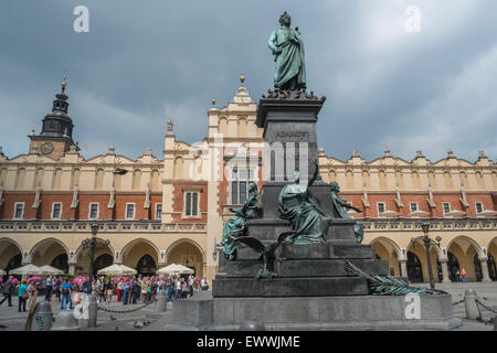 Adam Mickiewicz bronze monument in Kraków old town, with Sukiennice (Cloth Hall) in the background, Krakow, Poland. Stock Photo