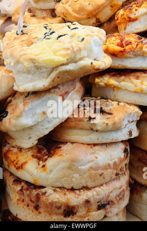 A stack of artisan bread for sale on a fine food market stall, England UK Stock Photo