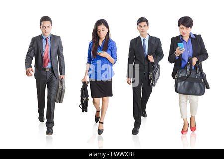 4 indian Business Partner  Walking and Dialling  Cell Phone Stock Photo