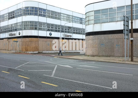 Boarded up former car showroom in Cardiff South Wales UK Stock Photo