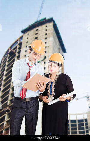 2 indian Architect Construction Site Clipboard Discussion Stock Photo