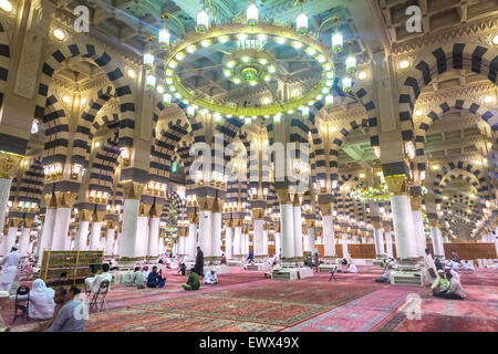 AL MADINAH, KINGDOM OF SAUDI ARABIA - MAR 07: Muslim pray and read Quran inside Masjid (mosque) Nabawi on March 07, 2015 in Al M Stock Photo