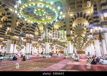 AL MADINAH, KINGDOM OF SAUDI ARABIA - MAR 07: Muslim pray and read Quran inside Masjid (mosque) Nabawi on March 07, 2015 in Al M Stock Photo