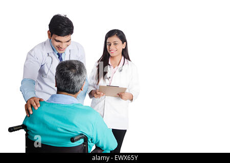 indian Doctor and Patient Wheelchair sitting Talking Stock Photo