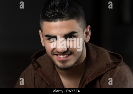 Young Muslim Man Making Traditional Prayer To God While Wearing A Traditional Cap Djellaba Stock Photo