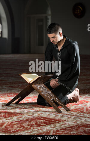 Arabic Muslim Man Reading Holy Islamic Book Koran Stock Photo