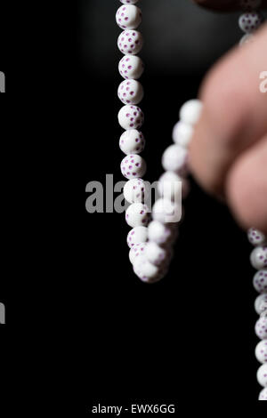 Close-Up Of Young Muslim Man With Rosary Praying In Mosque Stock Photo