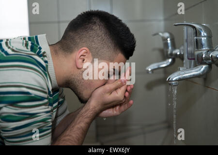 Muslim Man Preparing To Take Ablution In Mosque Stock Photo