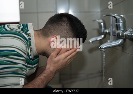 Muslim Man Preparing To Take Ablution In Mosque Stock Photo