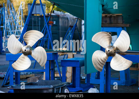 Twin shiny propellers freshly polished on a large sailing yacht out of the water at Newport Shipyard, R.I. Stock Photo