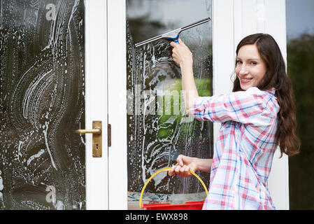 Portrait Of Woman Cleaning House Windows Stock Photo