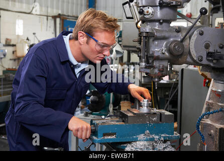Engineer Using Drill In Factory Stock Photo