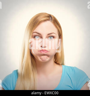 PoBlonde woman making pout Stock Photo