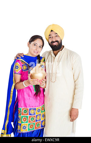 2 indian Punjabi Married Couple Saving money Piggy Bank Stock Photo - Alamy