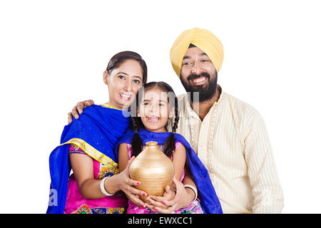 indian Punjabi Parents and daughter Saving money Piggy Bank Stock Photo