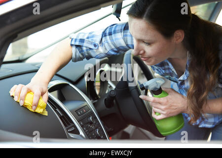 Woman cleaning inside of car Stock Photo - Alamy