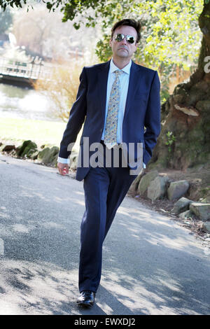 Smart middle-aged man in business suit and sunglasses Stock Photo