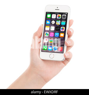 Varna, Bulgaria - December 07, 2013: Female hand holding Apple Silver iPhone 5S displaying iOS 8 mobile operating system Stock Photo