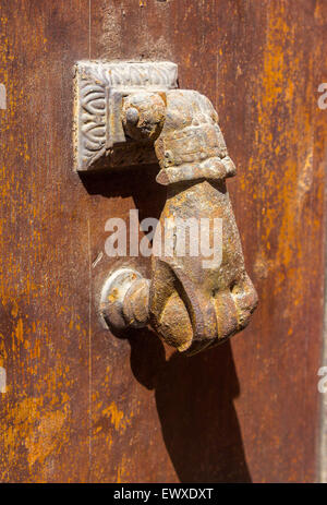 Old brass knocker shaped hand door Stock Photo